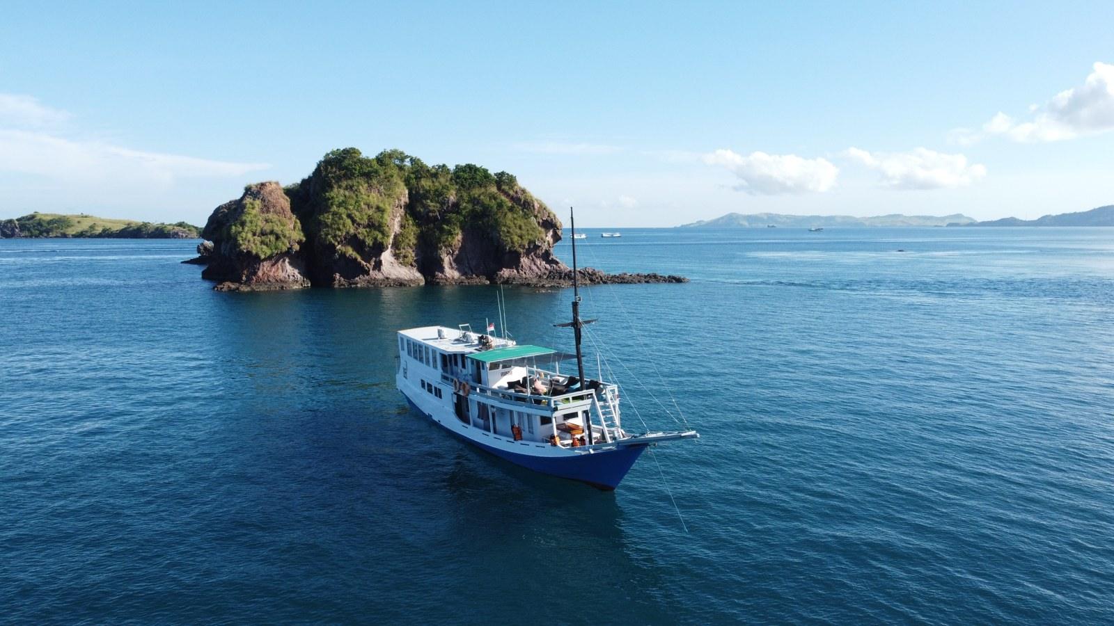 Princess Lala at anchor beside a rocky islet